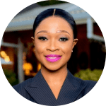 A person in a suit with her arms crossed

Description automatically generated